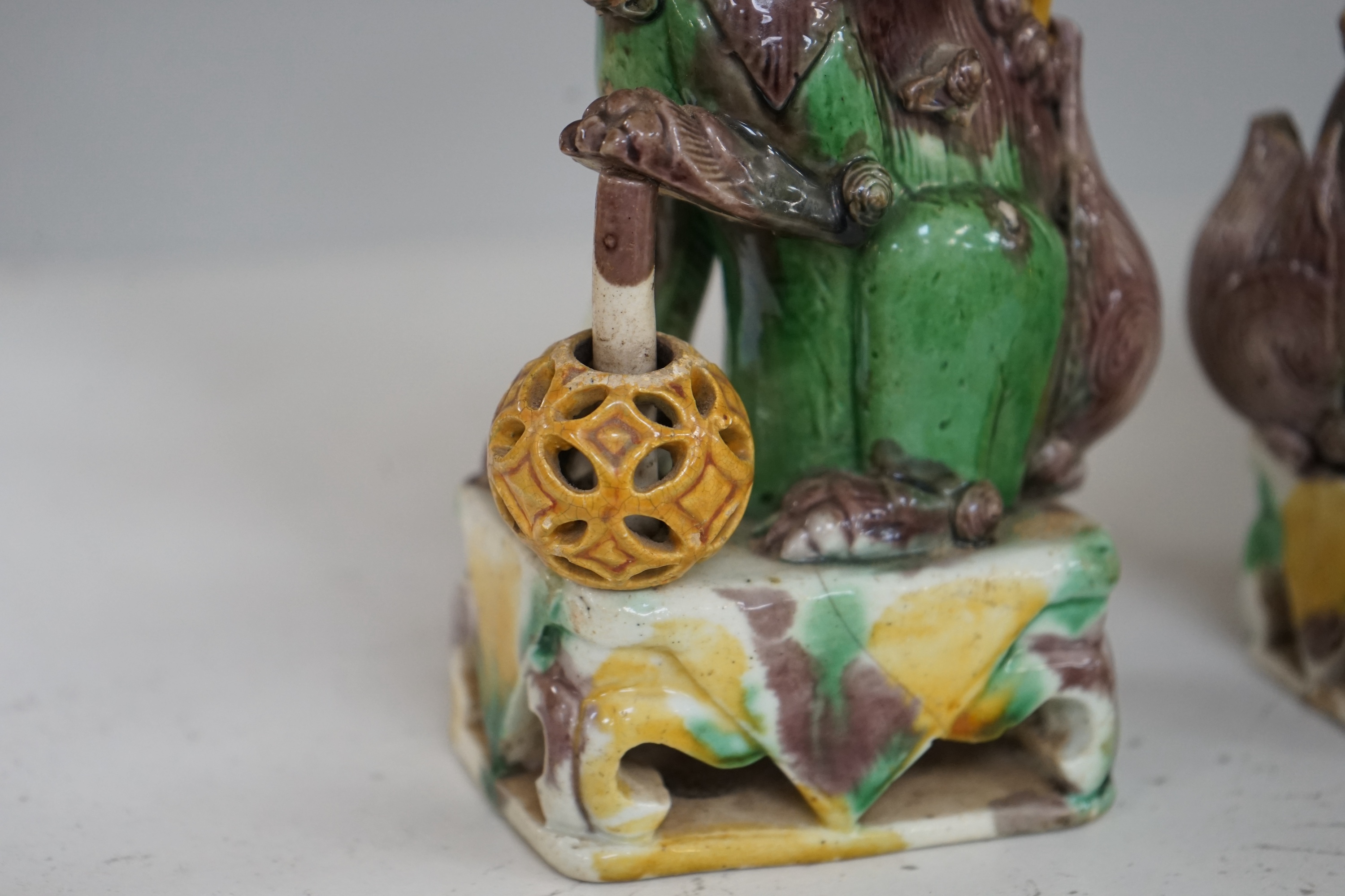 A pair of Chinese Sancai glazed lion joss stick holders, 18th century, 17cm high. Condition - some restoration